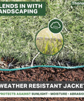 Green Outdoor Extension Cord 200 Ft 16 Gauge 3 SJTW Weatherproof Heavy Duty Cable blending with landscaping in garden setting