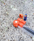 Pocket Ready Muzzleloader Quick Loader Kit with BH209 tubes and funnel on rock surface.