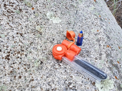 Pocket Ready Muzzleloader Quick Loader Kit with BH209 tubes and funnel on rock surface.