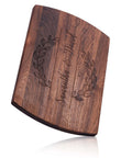 Front view of a personalized wooden cutting board with engraved names and date inside a laurel wreath design.