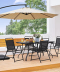 Outdoor Folding Patio Chairs Set Of 4 For The Backyard And Porch, Easy Fold And Portable, around a table under a large umbrella
