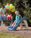 Toddler sliding on Play And Fold Junior Slide For Toddlers 1.5 To 4 Years Old Indoor Outdoor Backyard Playground Set at a party.