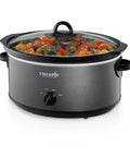 Huge 7 Quart Manual Slow Cooker Serving As A Real Weeknight Hero With Removable Stoneware Pot, High And Low Settings Plus Auto Warm Mode, No Fuss Dishwasher Safe Cleanup, Charcoal Finish filled with colorful vegetables.