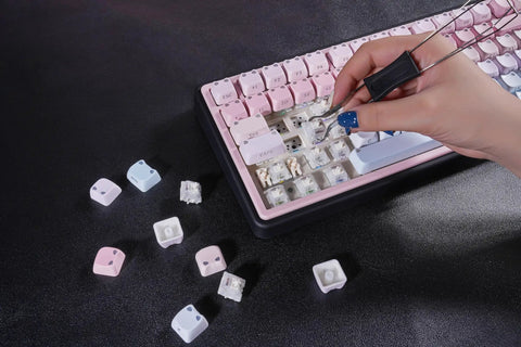 Close-up of hand using tool to change keycaps on Cute Bubble Cat Wireless Mechanical Keyboard Hits Different With Creamy 75 Percent Layout Hot Swappable Switches Cat Ear Shine Through Keycaps Triple Mode RGB Gaming Board For Mac And PC Users Wanting Top Tier Vibes.