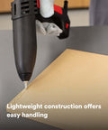 Single-unit industrial hot-melt applicator TC/TC-Q GEN II applying adhesive on cardboard surface
