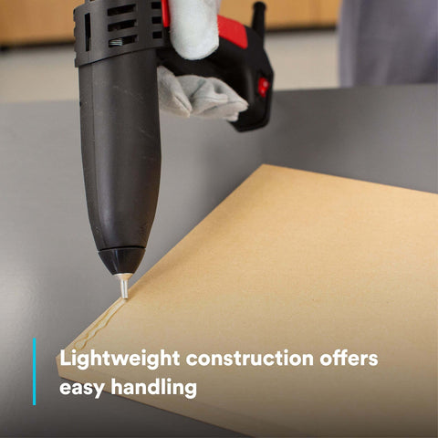 Single-unit industrial hot-melt applicator TC/TC-Q GEN II applying adhesive on cardboard surface
