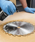 Person cleaning saw blade with Blade And Bit Cleaner For Tools 18 Fl Oz Resin Pitch And Rust Remover Safe Non Toxic Formula