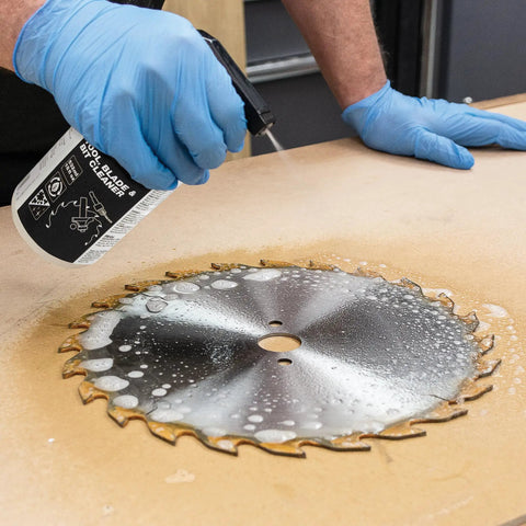 Person cleaning saw blade with Blade And Bit Cleaner For Tools 18 Fl Oz Resin Pitch And Rust Remover Safe Non Toxic Formula