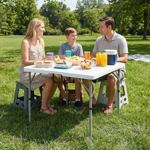 Family enjoying a picnic using a 34 Inch Folding Square Card Table Portable Heavy Duty HDPE Fold In Half With Carrying Handle
