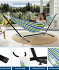 Two Person Hammock With Stand For Outdoors And Indoors Double Portable Hammock Set With Space Saving Heavy Duty Steel Stand Carrying Bag Included Weather Resistant Patio And Backyard Lounging 450 Lb Capacity in blue-green stripes on a patio.