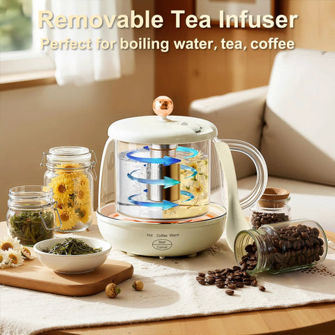 Glass electric kettle with removable infuser, surrounded by jars of tea leaves and coffee beans, on a wooden countertop.