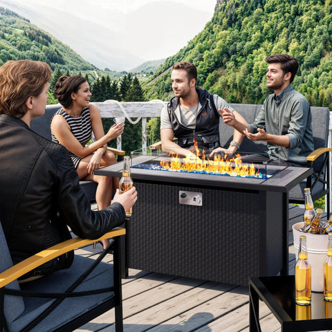 Group enjoying an outdoor evening around 45 Inch Propane Fire Table With 50000 BTU Fire Pit, Glass Wind Guard And Rain Cover