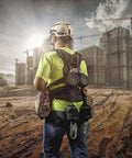Worker at construction site wearing H1 V-Gard Safety Helmet With Fas-Trac III Ratchet Suspension, Polyethylene Shell, Black