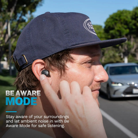 Totally Wireless Earbuds Featuring Instant Plug And Play Pairing Slick Bass Boost Audio And Compact USB Case Bluetooth Five Point Three Black Edition in use with ambient mode activated outdoors.