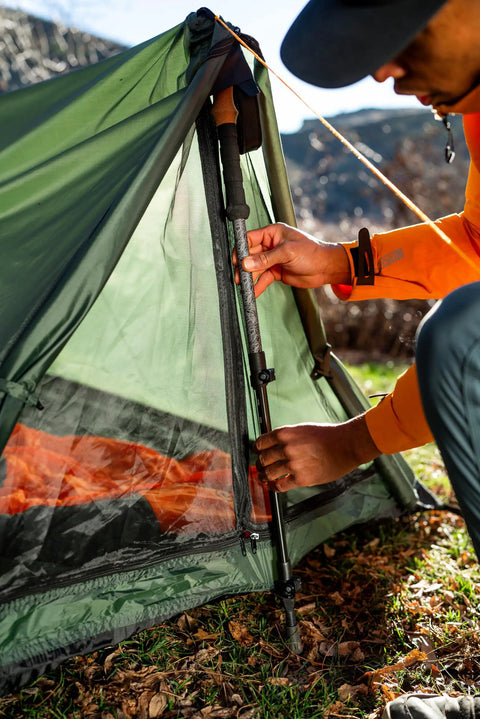 Person setting up Forest Scout Backpack Tent for Quick Camp Setup Lightweight Frame Shelter With 1000mm PU Coated Polyester