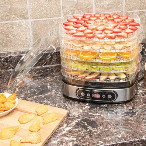 Heavy Duty 5 Tier Food Dehydrator Machine With 48 Hour Delay Timer And Easy Spin Dials with drying fruits on top.