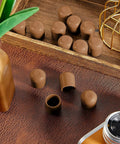 Hella Tough Brown Folding Chair Leg Caps 12 Pack on a wooden surface, solid rubber bumpers designed for 7/8 inch steel tubes.