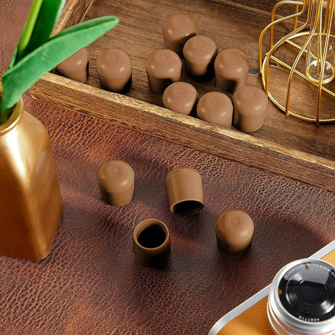 Hella Tough Brown Folding Chair Leg Caps 12 Pack on a wooden surface, solid rubber bumpers designed for 7/8 inch steel tubes.