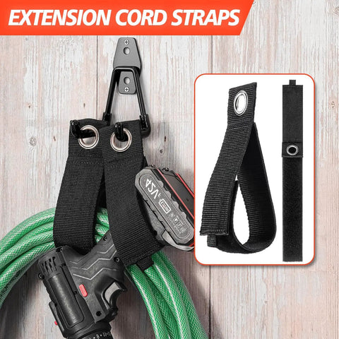 Black extension cord straps with grommet holes holding a green hose and power tool, shown on wood background.