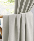 Close-up of 100 Percent Blackout Linen Curtains in Greyish Beige, 50x126 Inches, Two Panels draped over a chair in a living room.