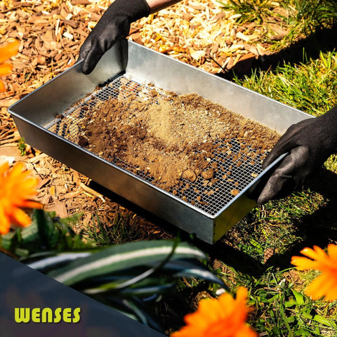 Person using Wide Soil Sifter for Garden and Landscaping 17.5 by 11.5 Inch Mesh Sieve with 1/4 Inch Holes filled with soil