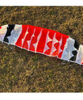 150cm Wingspan RC Paraglider PNP Kit With 2300KV 2205 Brushless Motor flat on grass showing multicolored nylon canopy