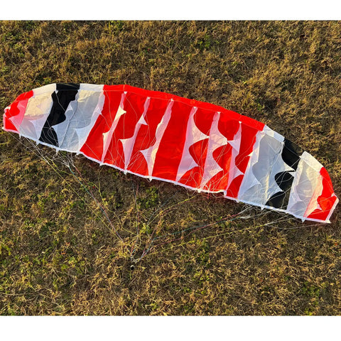 150cm Wingspan RC Paraglider PNP Kit With 2300KV 2205 Brushless Motor flat on grass showing multicolored nylon canopy