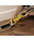 Person using Oscillating Multi Tool Kit With 3 Amp Motor Dual Grip Variable Speed Trigger Quick Change System on wooden floor