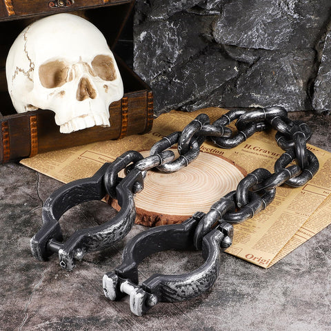 Halloween Plastic Wrist Shackles Handcuffs With Chain Links For Cosplay And Party Decor on stone surface with skull prop