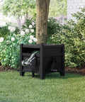 Hideaway Hose Reel With 100 Ft Capacity, Durable Resin Garden Hose Organizer outside in garden, black and gray finish.