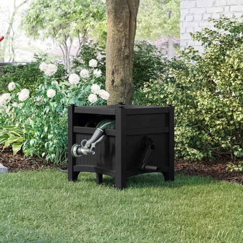 Hideaway Hose Reel With 100 Ft Capacity, Durable Resin Garden Hose Organizer outside in garden, black and gray finish.