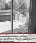 Cracked glass sliding patio door with caution notice, wooden deck visible outside