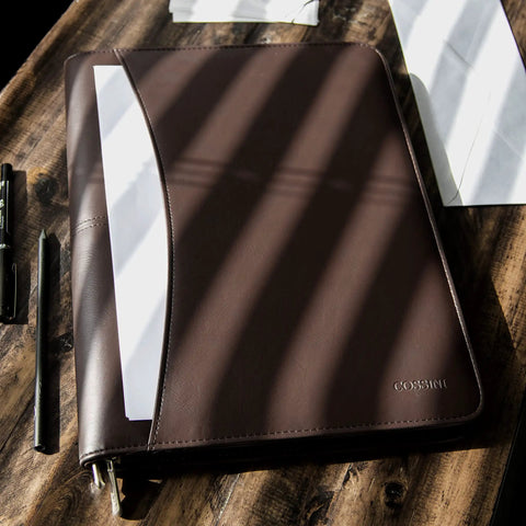 Career Game Changer Business Padfolio With Heavy Duty Zipper Closure Crafted From Smooth Pu Vegan Leather featuring a brown exterior and white documents.