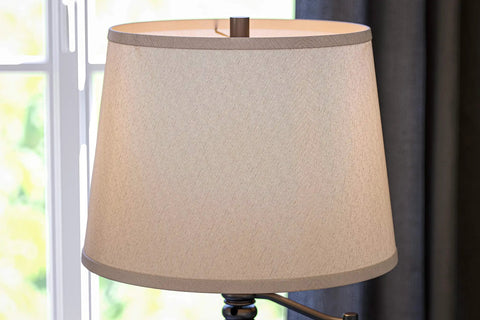Riverside Copper Bronze Swing Arm Floor Lamp With Cozy Warm Glow Oatmeal Drum Shade up close