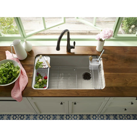 Riverby White Rinsing Colander With Built In Cutting Board in kitchen sink, durable plastic for rinsing vegetables, pasta prep.