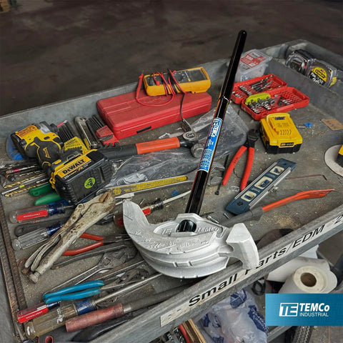Get This Awesome 2 in 1 Dual Shoe Conduit Bender For Quick EMT And Rigid Pipes on a tool table with various tools.