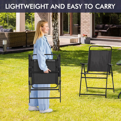 Woman carrying folded Outdoor Folding Patio Chairs Set Of 4 for the Backyard and Porch, lightweight and portable, black metal frames.