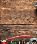 Ditch Your Wonky Flip Lid With These Rock Solid Stainless Steel Torsion Springs And Make DIY Repairs A Breeze For Any Trash Can In The Kitchen Or Home, two silver torsion springs on wood