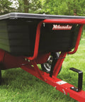 Rock Solid Six Hundred Fifty Pound Poly Dump Cart For Tough Job Site Hauling with pneumatic tires and spring-loaded hitch.