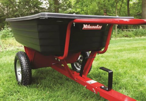 Rock Solid Six Hundred Fifty Pound Poly Dump Cart For Tough Job Site Hauling with pneumatic tires and spring-loaded hitch.