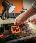 Badass Heavy Duty Workhorse Bench Grinder And Belt Sanders Combo With Variable Speed Motor in use for tool sharpening.
