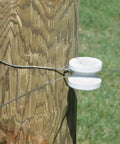 Zareba large white ceramic corner post insulator on wood post for electric fencing