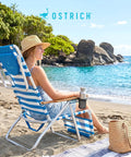 Woman relaxing on a 3N1 Lightweight Beach Reclining Lounge Chair With Footrest, blue stripe, at a sunny beach.