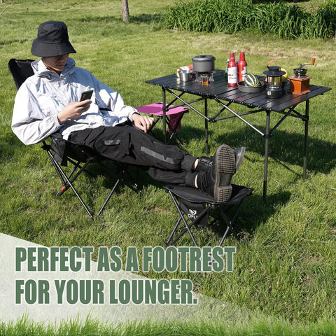 Person using Two Pack Folding Camping Stool With Upgraded Latch Buckle as footrest at outdoor picnic