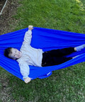 Kid Friendly Camping Hammock For Indoors And Outdoors, Ultra Comfy Hangout Hammock For Kids with child lying in blue hammock