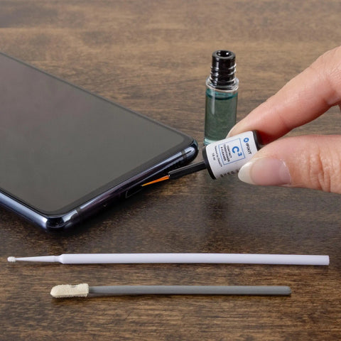 Phone Laptop Tablet All In One Cleaning Kit With Precision Spudgers, tweezers, DeoxIT D100L, swabs, and micro brushes shown with phone.