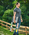Man carrying 8.5 Ft Aluminum Telescoping Ladder For Home DIY Projects Foldable Extension With 12 Ft Reach Lightweight Portable