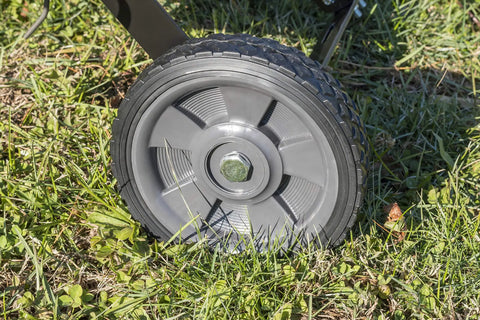 Close-up of the wheel on a 40 Inch Tow Behind Lawn Dethatcher Beast With 20 Durable Spring Steel Tines, Universal Hitch, on grass