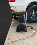 Man using Outdoor 100 Foot 14/3 Gauge Extension Cord With Lighted End For All Purpose Power On Job Sites And At Home.