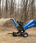 Towable 6 Inch Wood Chipper With Electric Start 15HP 420cc Gas Powered Engine in forest, chipping wood debris